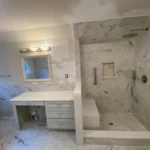 Marble vanity with tiled shower niche