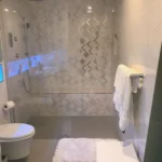 Shower with blue lit tile niche