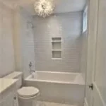 Tub and shower combo with round mirror