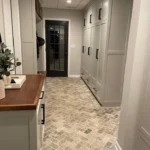 Foyer with wood accent door and stone tile flooring