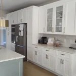 White kitchen with built-in coffee station and marble countertops