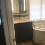 Dark vanity with window in bathroom