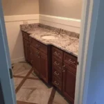Bathroom vanity with granite countertop and mirror