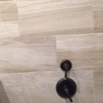 Tile shower wall with oil rubbed bronze fixtures