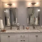 Double vanity with mirrors and sconce lighting