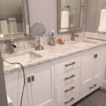 White vanity with granite countertop