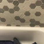 Hexagon tile shower wall with tub