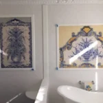Bathroom with decorative tile art on wall