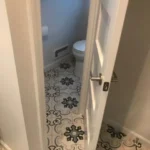Bathroom hallway with patterned tile flooring