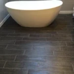 Freestanding oval tub with wood look flooring