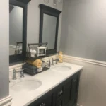 Dark wood double vanity with white countertop