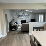 Kitchen with stone accent wall opening into living room