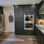 Dark navy kitchen with built-in double wall ovens
