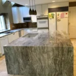 Close-up of green-veined marble waterfall island corner