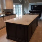 Dark kitchen island with white marble countertop