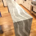 Close-up of gray veined marble waterfall countertop edge