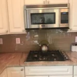 Close-up of built-in microwave and gas cooktop