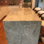 Close-up of gray marble waterfall island corner