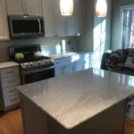 Kitchen with gray marble island and gray cabinetry