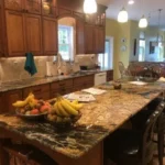 Dark wood kitchen with granite island and fruit bowl