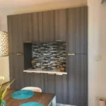 Kitchen niche with mosaic tile backsplash and pendant lighting
