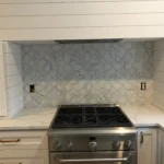 Kitchen with tile backsplash and gas range