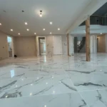 Foyer with marble flooring and columns